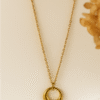 Minimal gold circular pendant necklace with smooth finish on gold chain