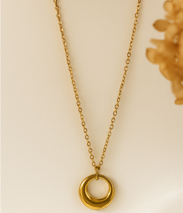 Minimal gold circular pendant necklace with smooth finish on gold chain